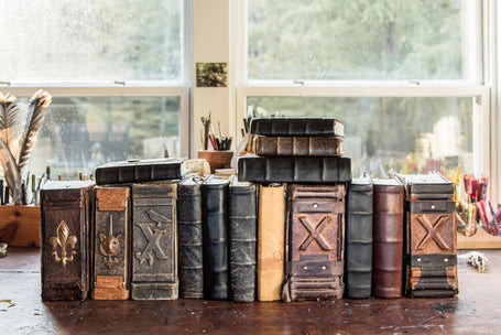 A collection of massive handbound and filled tomes by Margaux Kent of Peg and Awl 
