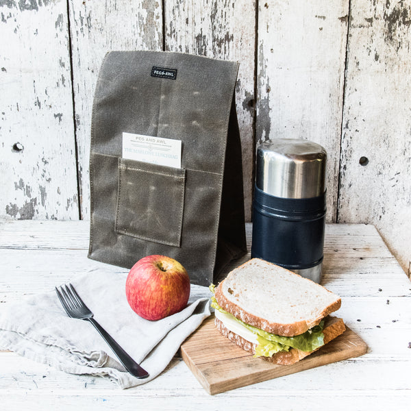 https://pegandawlbuilt.com/cdn/shop/products/Lunch-Bag-Container-Waxed-Canvas-Truffle-Brown-Peg-And-Awl_07_grande.jpg?v=1699583652